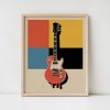 Framed electric guitar poster featuring red guitar against colorful geometric background with orange, yellow, blue, and black blocks in retro pop art style