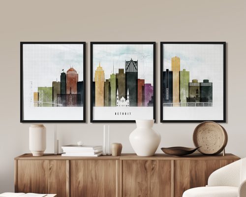 Three framed art prints depicting the skyline of Detroit in muted colors on a wall.