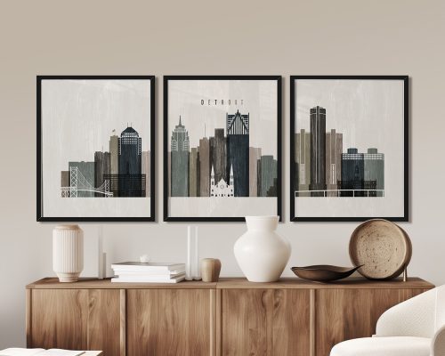 Three framed art prints depicting a stylized cityscape of Detroit with various buildings and structures.