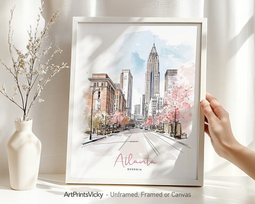 Hand holding a framed art print of Atlanta in watercolor drawing with soft pastel tones.
