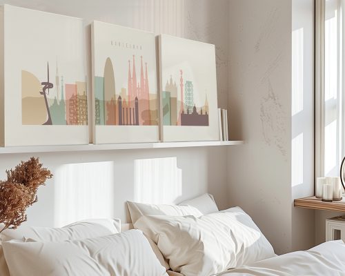 Three canvas prints of a stylized Barcelona cityscape displayed on a shelf above a bed.
