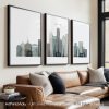 Three framed art prints depicting a stylized cityscape of Boston with various buildings.