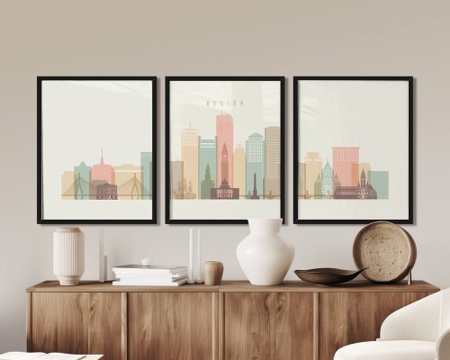 Three framed art prints of a stylized Boston city skyline with pastel colors.