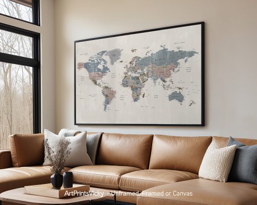 A world map displayed in a framed format on a wall above a couch in a living room.
