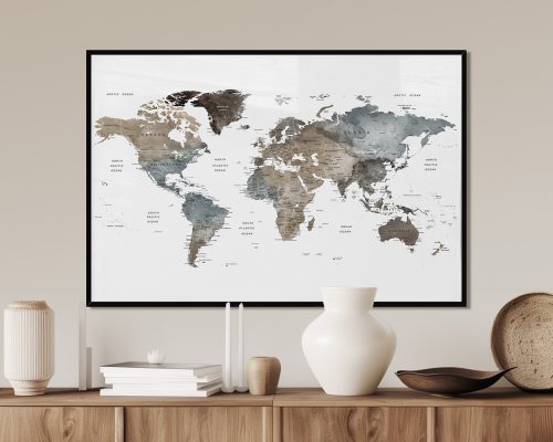 World map featuring earth tone colors, displayed in a framed format on a wall.