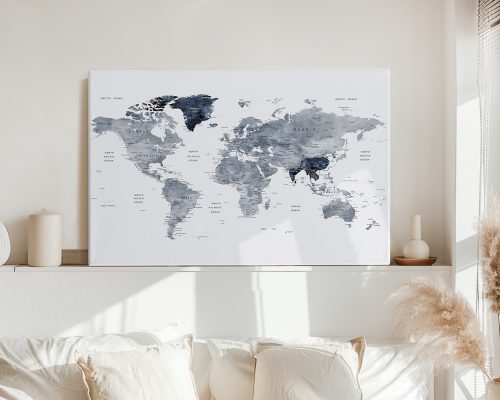 World map artwork featuring grey and blue tones displayed on a wall above a sofa.