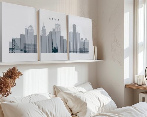 Three-panel artwork depicting the Detroit city skyline in gray tones displayed above a bed.