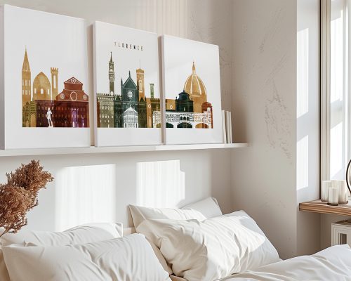Three framed artworks depicting architectural landmarks of Florence displayed on a shelf above a bed.