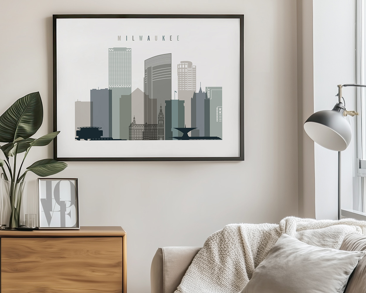 Framed artwork depicting the skyline of Milwaukee with various buildings and structures.