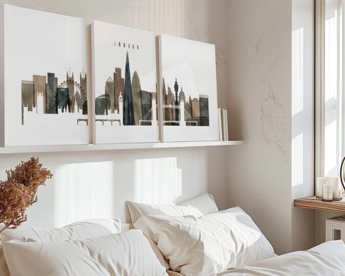 Three canvas art prints of a London cityscape displayed on a shelf above a bed.