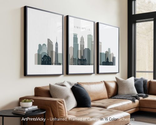 Three framed cityscape prints of Minneapolis displayed on a wall above a couch.