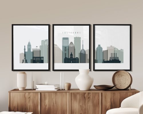 Three framed art prints depicting the Baltimore city skyline in muted colors.