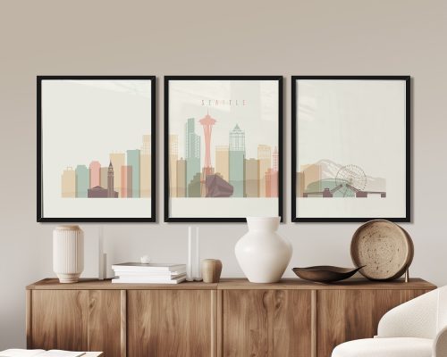 Three framed art prints depicting a stylized Seattle skyline with the Space Needle and Ferris wheel.