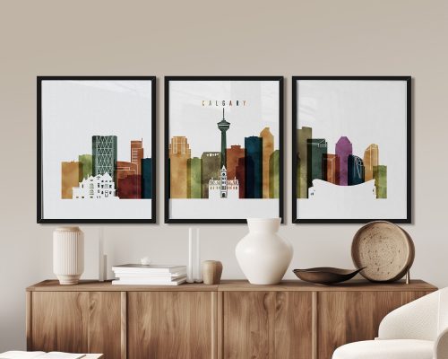 Three framed art prints depicting the Calgary skyline with various buildings and colors.