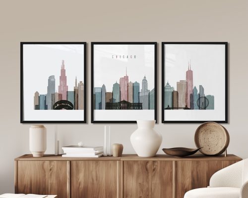 Three framed art prints of the Chicago skyline displayed on a wall above a wooden sideboard.