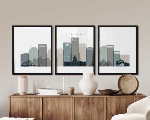 Three framed art prints depicting a stylized cityscape of Edmonton with buildings and a bridge.