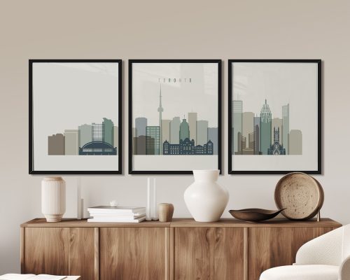 Three framed art prints depicting a cityscape of Toronto with various buildings and the CN Tower.
