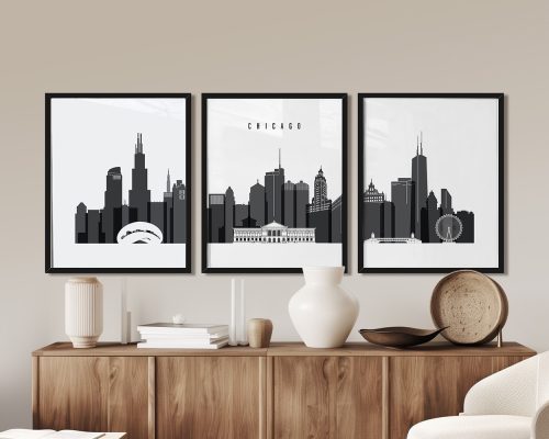 Three framed art prints of the Chicago skyline displayed on a wall above a wooden sideboard.
