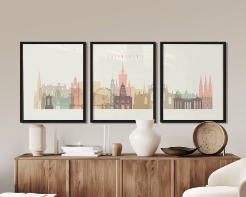 Three framed prints of Edinburgh's cityscape featuring notable buildings in pastel colors.
