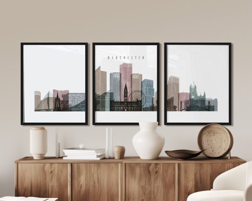 Three framed art prints depicting a stylized cityscape of Manchester with notable buildings.