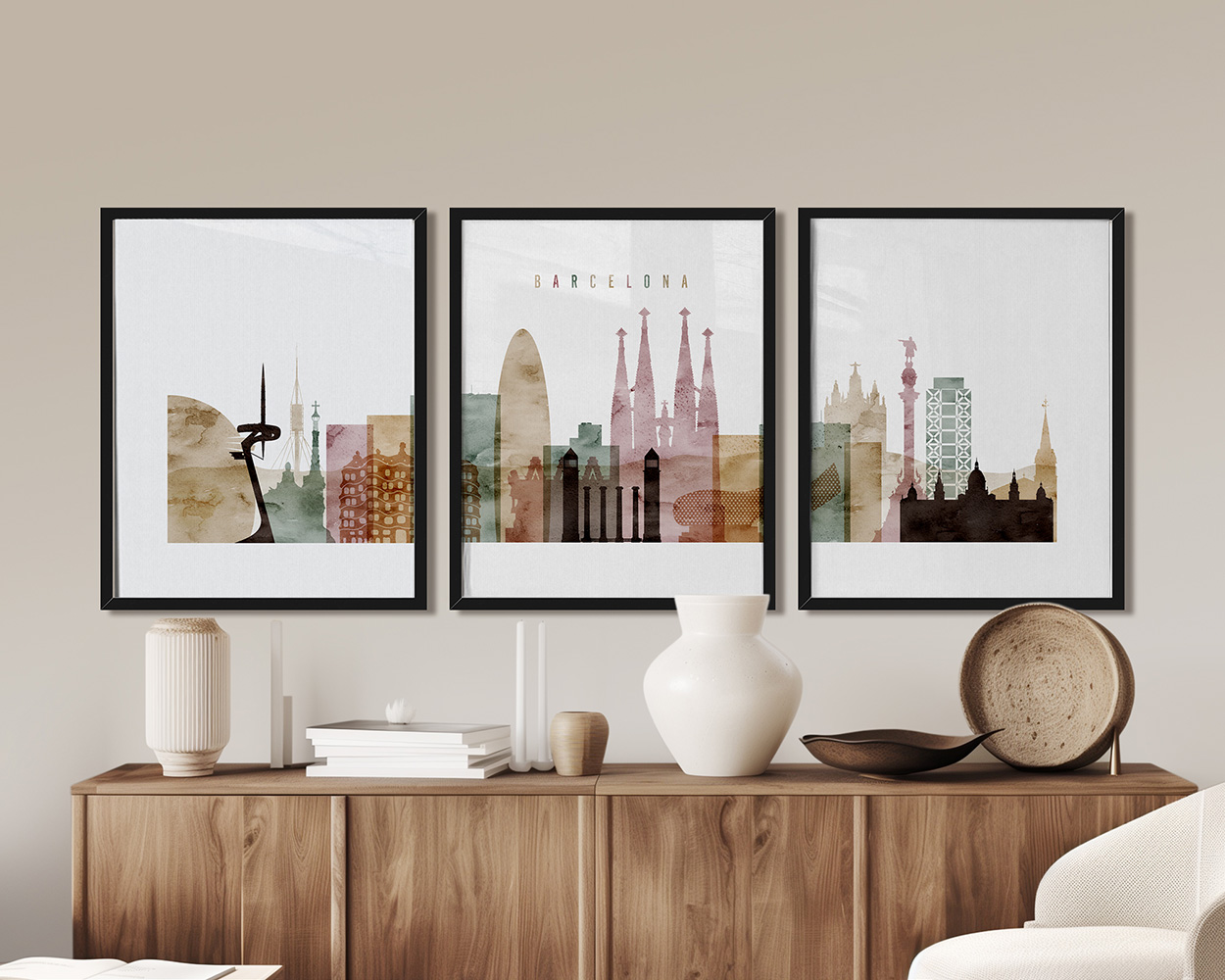 Three framed art prints depicting the skyline of Barcelona with various landmarks and colors.
