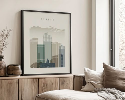 Framed artwork depicting a stylized cityscape of Denver with mountains in the background.