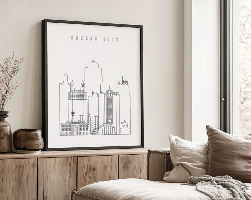 Line art illustration of Kansas City skyline framed and displayed on a wall.
