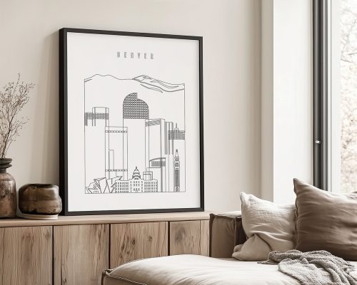 Framed line art print of Denver's skyline with mountains in the background.