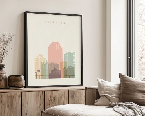 Framed art print of a Sarasota cityscape featuring stylized buildings in pastel colors.