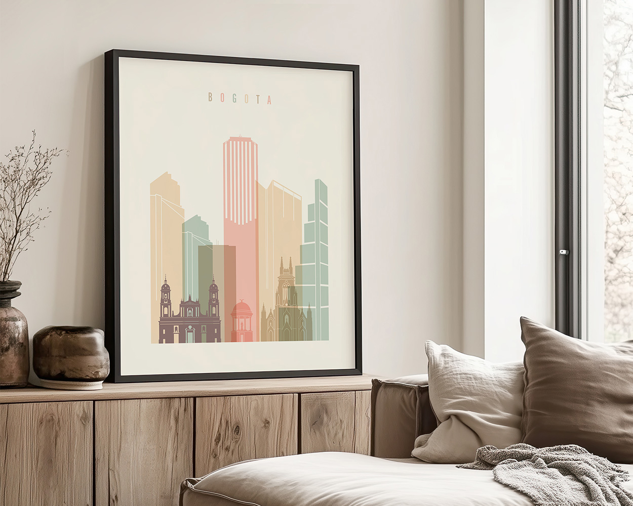 Framed artwork depicting a stylized cityscape of Bogotá with various building silhouettes.