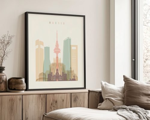 Art print of a cityscape featuring buildings and a tower in Madrid, framed and displayed indoors.