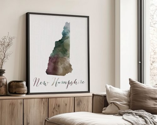 Watercolor map of New Hampshire framed and displayed on a wall with decorative elements.
