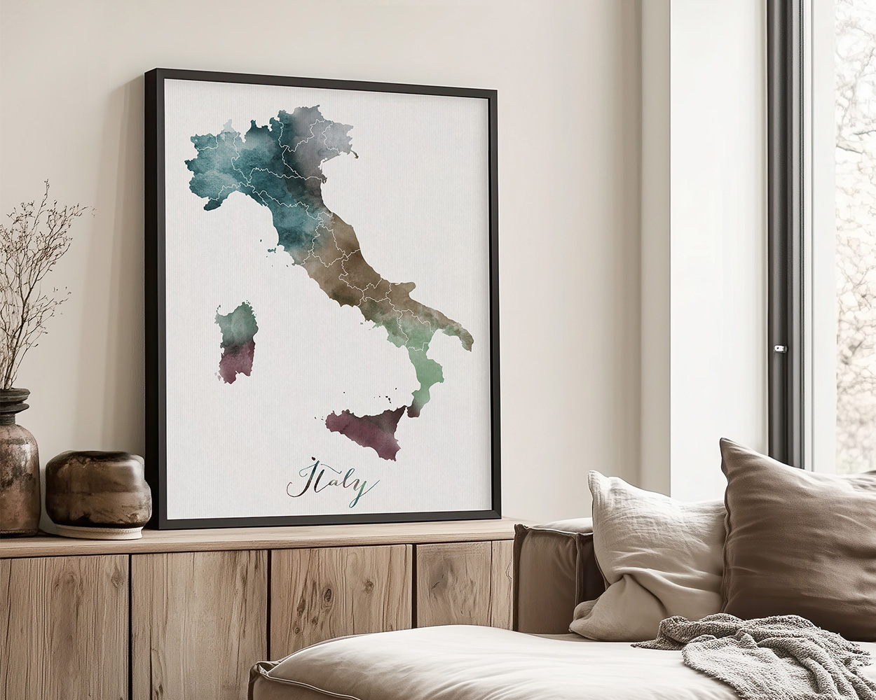 Watercolor map of Italy displayed in a black frame on a wall.