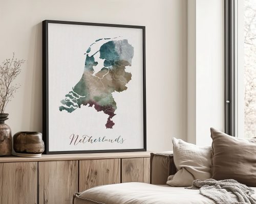 Watercolor map of the Netherlands displayed in a black frame on a wooden surface.