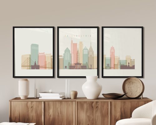 Three framed art prints of Philadelphia's skyline featuring iconic buildings and structures.