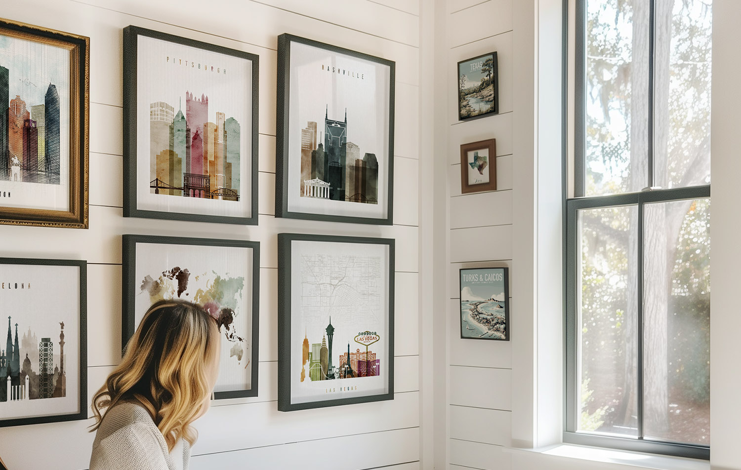 Various framed cityscape prints displayed on a wall, featuring different cities and landmarks.