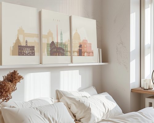 Three art prints depicting iconic buildings and landmarks of Rome displayed on a shelf above a bed.
