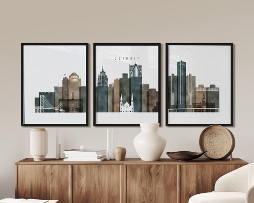 Three framed art prints depicting a stylized skyline of Detroit with various buildings.