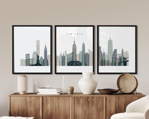 Three framed art prints depicting the skyline of New York City in muted colors.