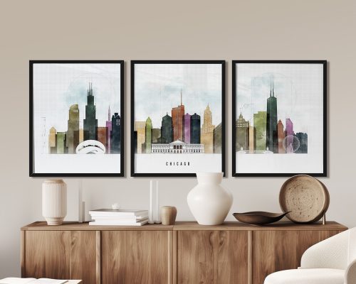 Three framed art prints of Chicago's skyline displayed on a wall above a wooden sideboard.