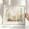 Framed artwork depicting a stylized cityscape of Sydney with notable landmarks.