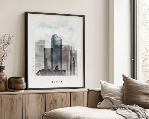 Framed artwork depicting a stylized cityscape of Denver with various buildings and a cloudy sky.