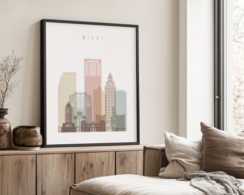 Framed artwork depicting a stylized cityscape of Miami with pastel colors and notable buildings.