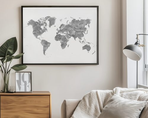 Grey world map displayed in a black frame on a wall.