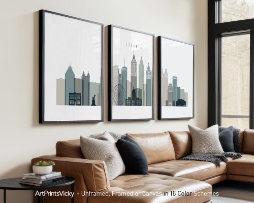 Three framed art prints of the Atlanta skyline displayed on a wall above a couch.