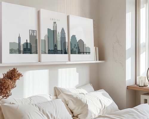 Three art prints depicting the skyline of Austin, Texas, displayed on a shelf above a bed.