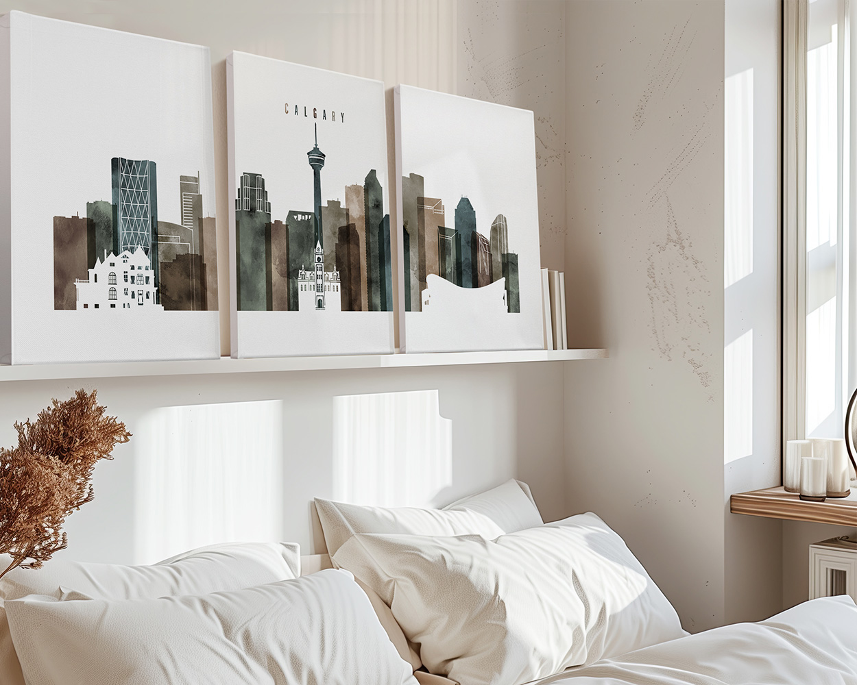 Three art prints of Calgary's skyline displayed above a bed in a modern interior.
