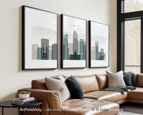 Three framed art prints of Denver's skyline displayed on a wall above a couch.