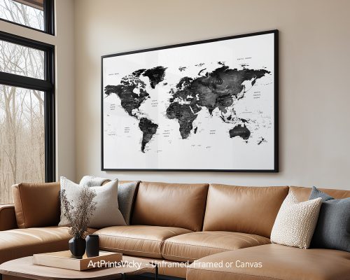 Black and white world map displayed in a large frame on a wall.