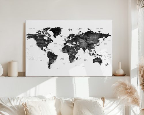 Black and white world map with country names and outlines displayed on a wall.